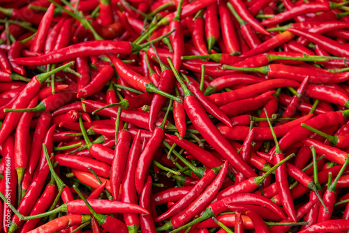 Pile of red spicy chili peppers at fresh market in Thailand.