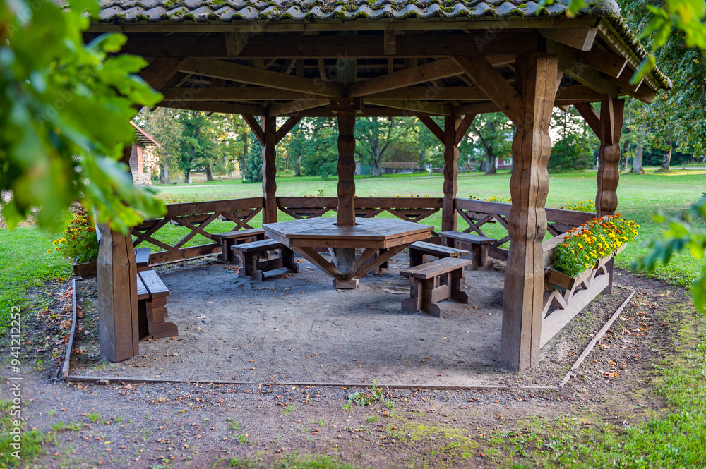 Large wooden gazebo shelter example. Gazebo with outdoor furniture. Large wooden gazebo shelter example. Gazebo with outdoor furniture.