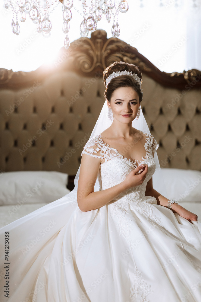 A woman in a wedding dress is sitting on a bed A woman in a wedding dress is sitting on a bed