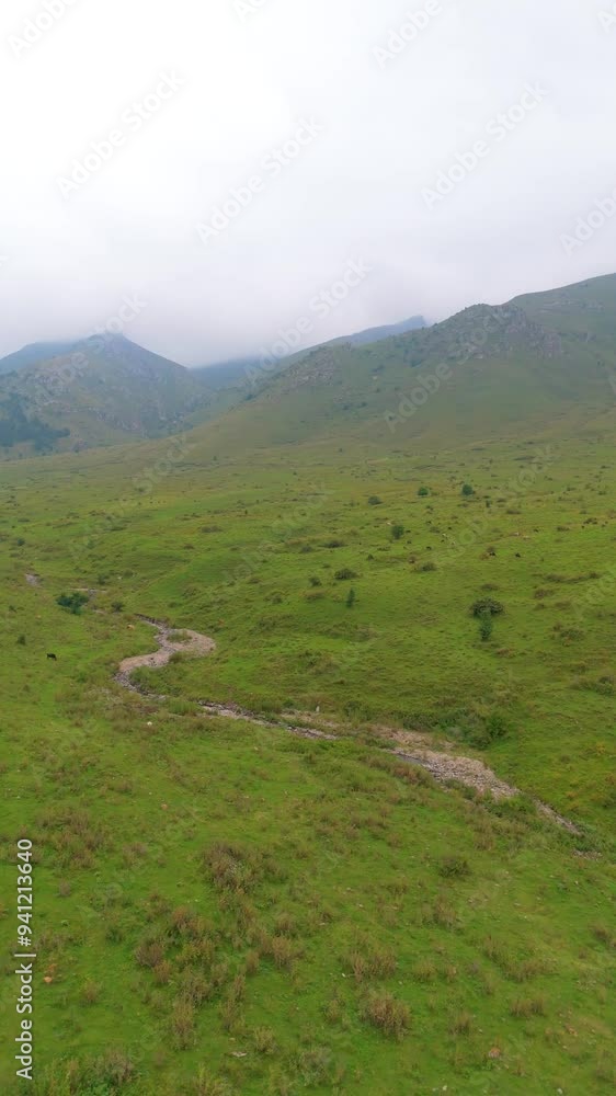 An aerial view of beautiful mountains and green field. Taken with a drone An aerial view of beautiful mountains and green field. Taken with a drone