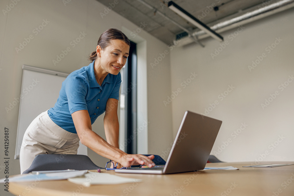 A dedicated and extremely focused professional intensely engaging with a laptop in a modern and contemporary workspace A dedicated and extremely focused professional intensely engaging with a laptop in a modern and contemporary workspace