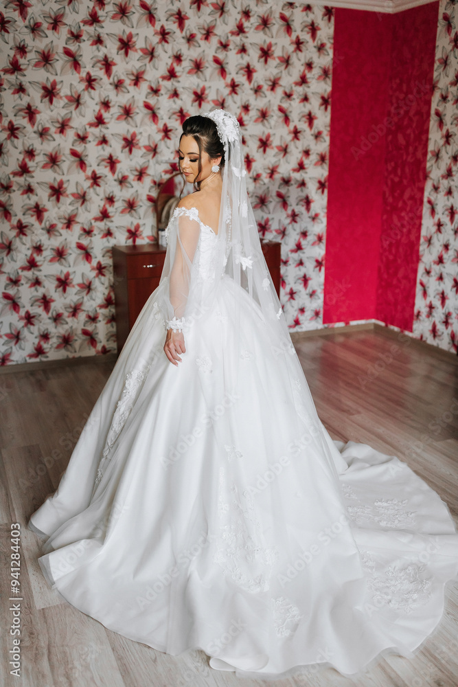A bride is standing in front of a red wall, wearing a white dress and a veil. The dress is long and flowing, and the bride is posing for a picture. Scene is elegant and romantic A bride is standing in front of a red wall, wearing a white dress and a veil. The dress is long and flowing, and the bride is posing for a picture. Scene is elegant and romantic