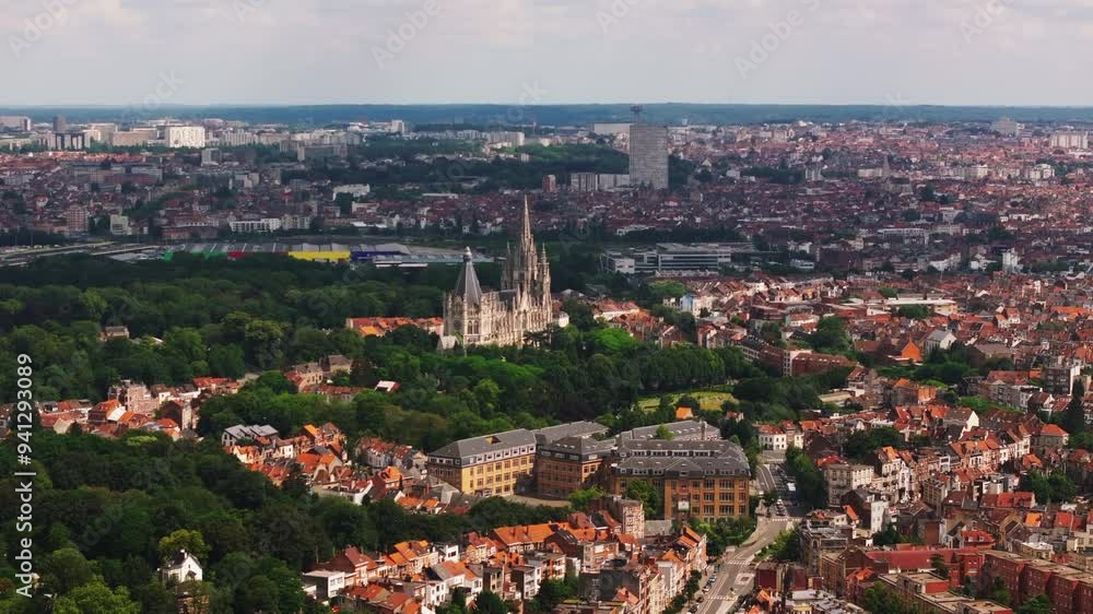 Brussels' skyline emerges as clouds drift across the cityscape, showcasing iconic architecture and vibrant green spaces from an aerial perspective Brussels' skyline emerges as clouds drift across the cityscape, showcasing iconic architecture and vibrant green spaces from an aerial perspective