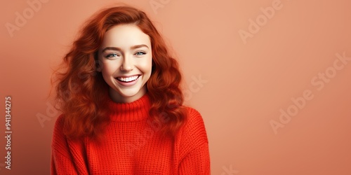 Portrait of a young red haired woman with pleasant smile over pastel background, bannerwith copy space. Beautiful girl in warm sweater photo