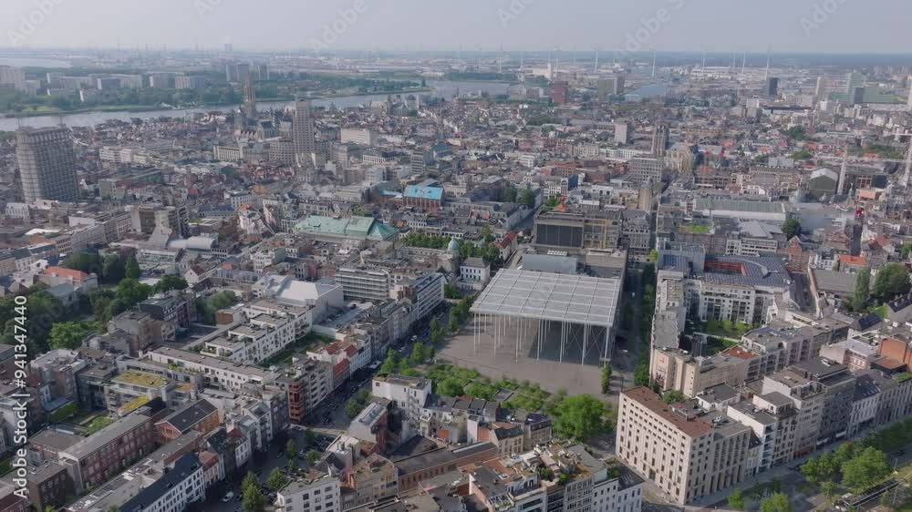 Panoramic views of Antwerp, Belgium, highlight Stadsschouwburg Antwerp theatre. The river scheldt flows elegantly in the background, complementing the urban scenery Panoramic views of Antwerp, Belgium, highlight Stadsschouwburg Antwerp theatre. The river scheldt flows elegantly in the background, complementing the urban scenery
