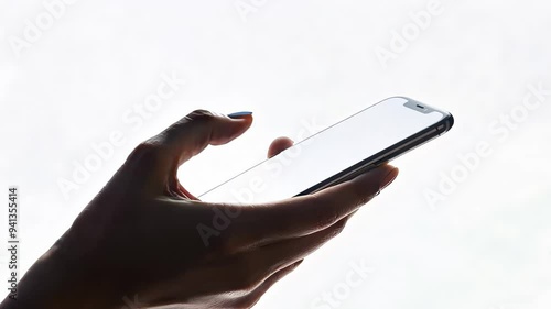 POV hand holding smartphone with blank white screen, isolated on light minimalist background