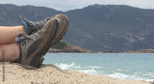 Relaxing on a spring beach in Corsica after a walk.
