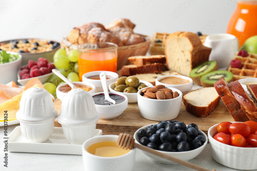 Different meals served for breakfast on white table Different meals served for breakfast on white table