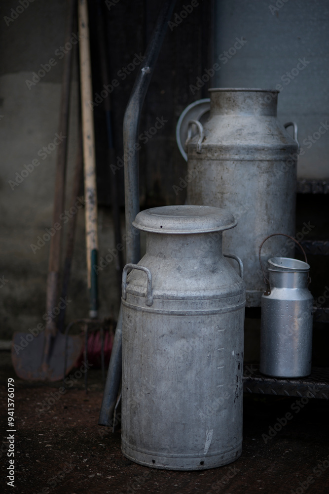 Different sizes of traditional milk churns on a Devon farm, UK. Different sizes of traditional milk churns on a Devon farm, UK.
