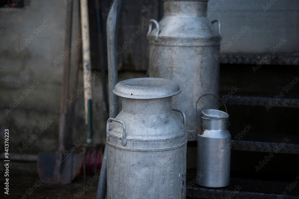 Different sizes of traditional milk churns on a Devon farm, UK. Different sizes of traditional milk churns on a Devon farm, UK.