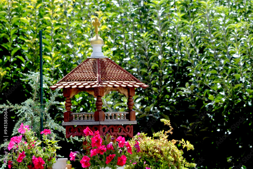 Beautiful bird feeder against the background of green vegetation Beautiful bird feeder against the background of green vegetation