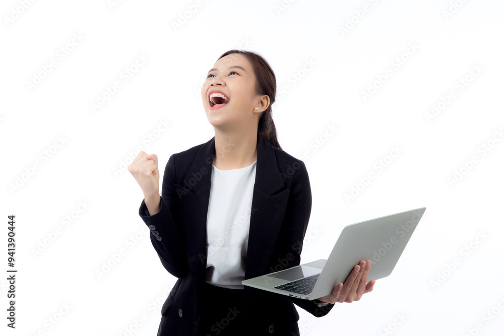 Portrait young asian businesswoman in suit celebrating success while holding a laptop isolated white background, business woman holding notebook expression with achievement and winning. Portrait young asian businesswoman in suit celebrating success while holding a laptop isolated white background, business woman holding notebook expression with achievement and winning.