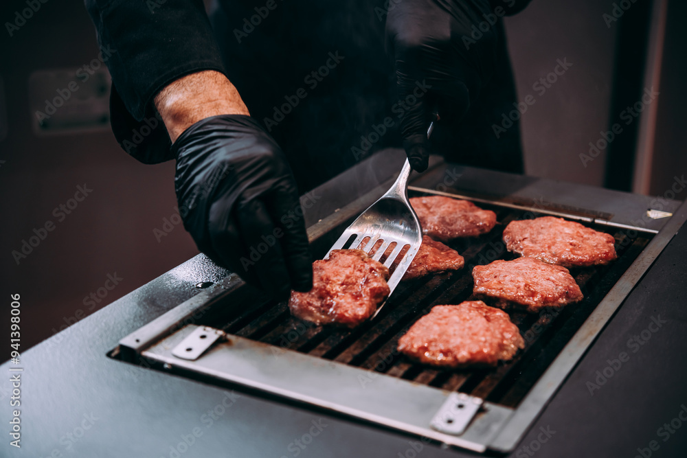 Grilling meat patties for classic burger in a cafe of a restaurant.
