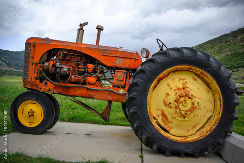 Antique tractor displayed on the agricultural field at the historic farmhouse in Park City, Utah, USA