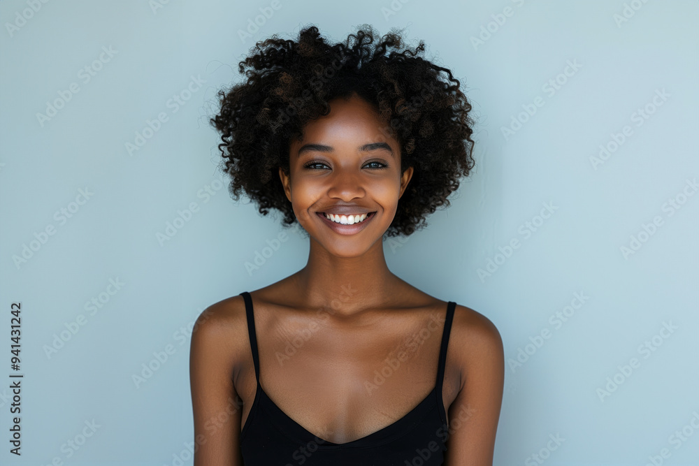 A series of portraits features a smiling young Black woman with natural curls, highlighted against simple white backdrops.
A series of portraits features a smiling young Black woman with natural curls, highlighted against simple white backdrops.