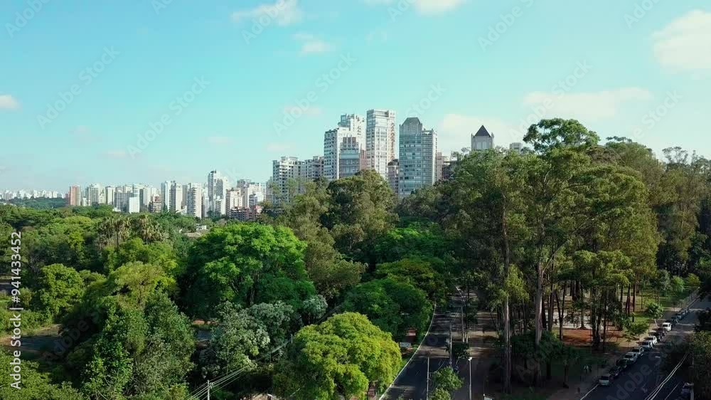 Aerial view of Ibirapuera Park in São Paulo, Brazil, with dense greenery and city skyscrapers in the background. Aerial view of Ibirapuera Park in São Paulo, Brazil, with dense greenery and city skyscrapers in the background.