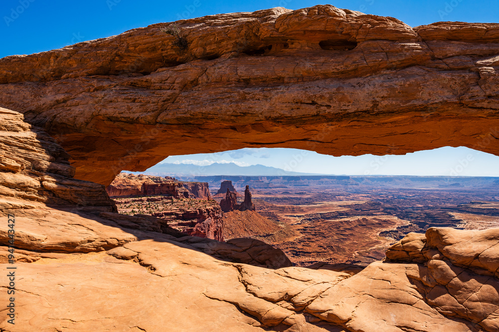 The most famous landmark of the Island in the Sky District of Canyonlands national park in Utah USA - The Mesa Arch in a blue day.