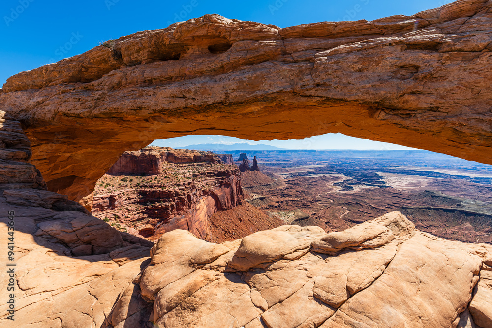 The most famous landmark of the Island in the Sky District of Canyonlands national park in Utah USA - The Mesa Arch in a blue day.