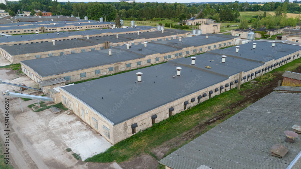 Drone photography of an old indoor chicken factory during summer day Drone photography of an old indoor chicken factory during summer day