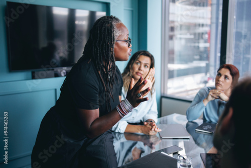 Mature black business woman discussing her strategy with her team in a boardroom