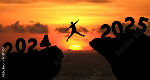 Concept Happy new year 2025 Silhouette image of happy man jump from 2024 up to 2025 on beautiful sky sunrise.