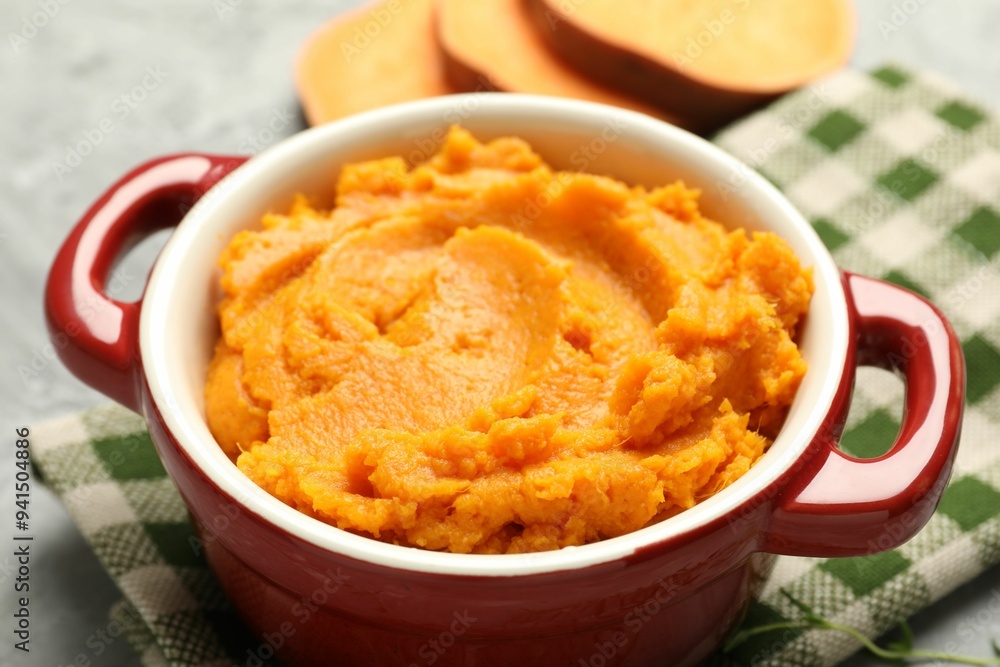 Delicious mashed sweet potatoes in pot on table, closeup Delicious mashed sweet potatoes in pot on table, closeup