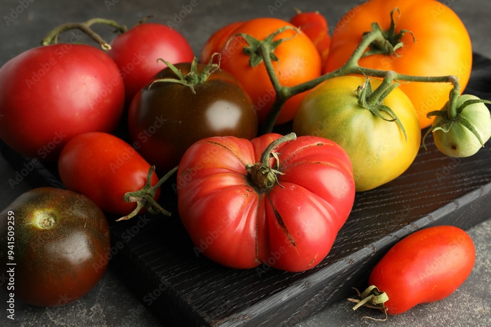 Different ripe tomatoes on grey table, closeup Different ripe tomatoes on grey table, closeup