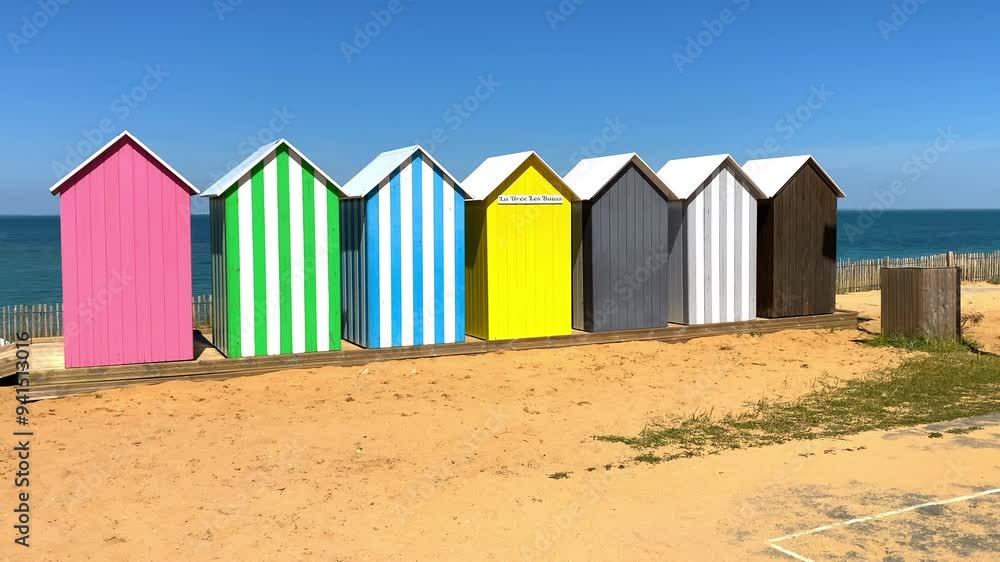 Multicolored bathing cabins of the beach of La Bree-les-Bains, France Multicolored bathing cabins of the beach of La Bree-les-Bains, France