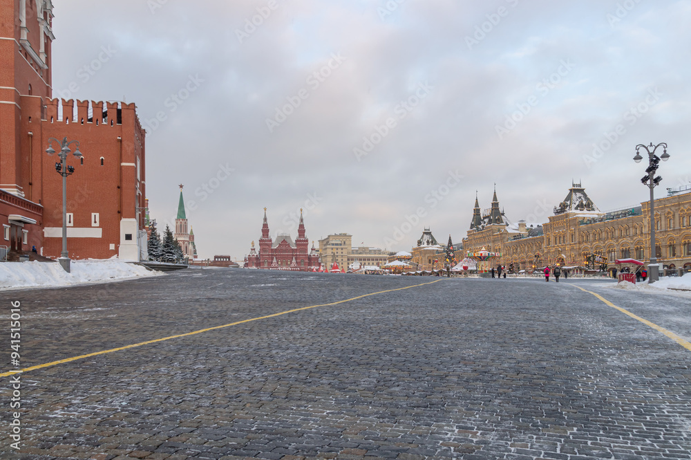 Obraz premium The Kremlin Wall in winter in Moscow. Red Square with a cobblestone pavement. Winter in Moscow on the eve of the New Year. Frosty weather in Moscow during the Christmas holidays.