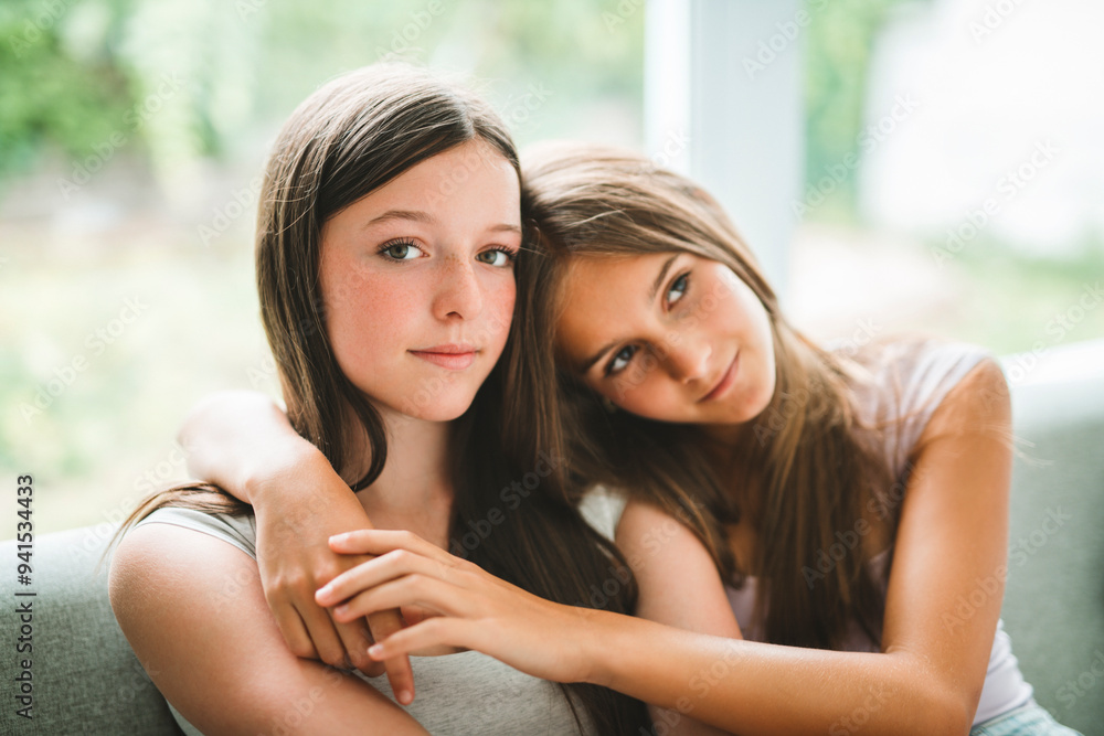 Fototapeta premium Two best girls having fun together on white studio
