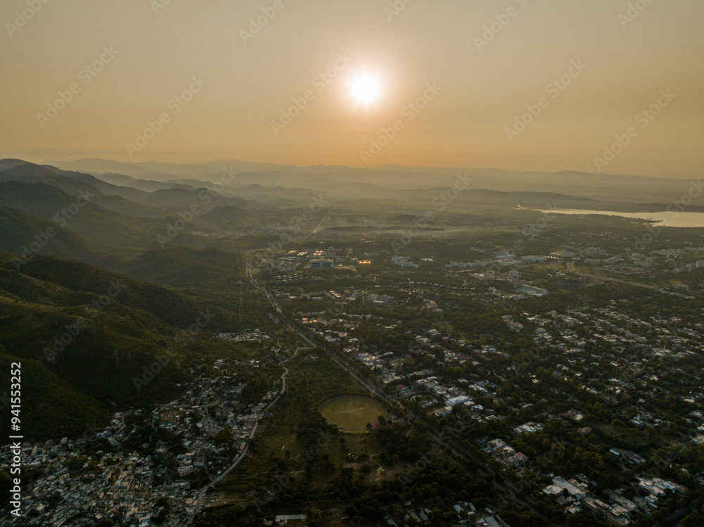 Obraz premium Aerial view taken from Margalla Hills of a the sun rising over Rawal Dam and the outskirts of Islamabad, Islamabad Capital Territory, Pakistan