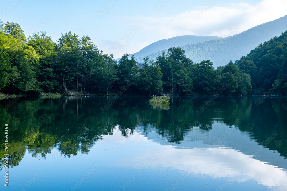 Lac de Bethmale - Pyrénées - Ariège - Lush Green Forest Surrounding a Reflective Lake Lac de Bethmale - Pyrénées - Ariège - Lush Green Forest Surrounding a Reflective Lake