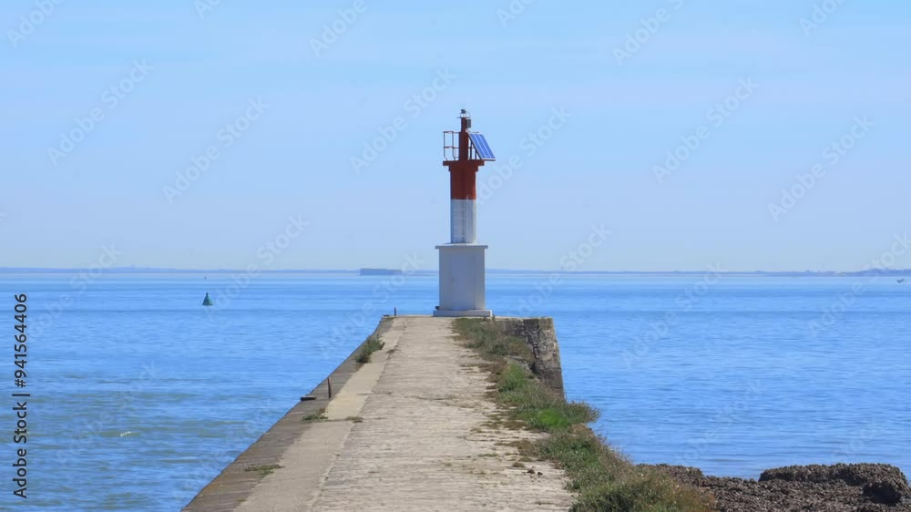 Guidance light and pier at the entrance of the channel of La Perrotine in Boyardville, France on Oleron island Guidance light and pier at the entrance of the channel of La Perrotine in Boyardville, France on Oleron island
