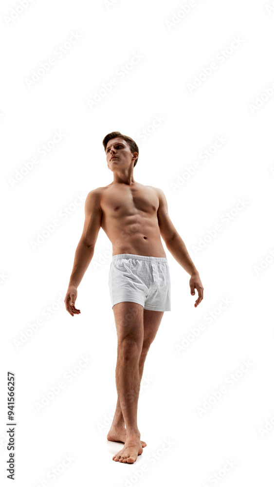 Photo of young man wearing underwear and posing leaning back demonstrate his athletic curves against white studio background. Concept of male health, natural beauty people, fashion, self care. Photo of young man wearing underwear and posing leaning back demonstrate his athletic curves against white studio background. Concept of male health, natural beauty people, fashion, self care.