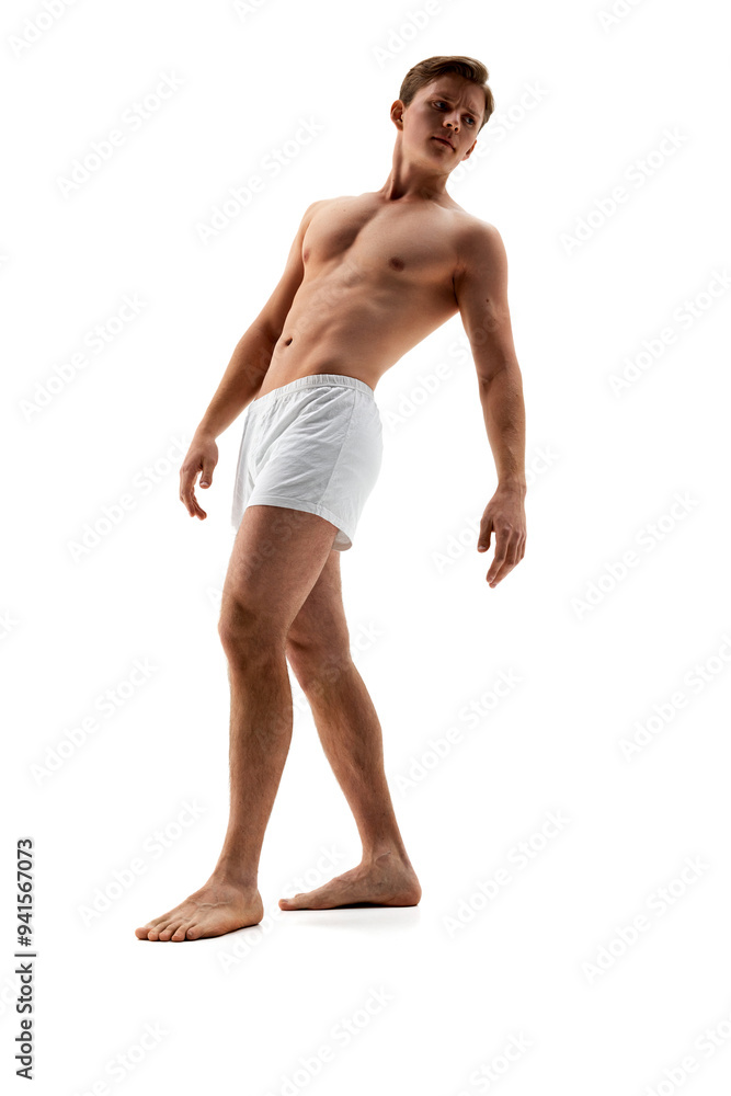 Photo of young man wearing underwear and posing leaning back demonstrate his athletic curves against white studio background. Concept of male health, natural beauty people, fashion, self care.
