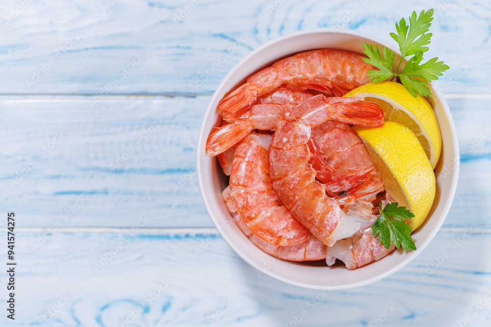 Fresh shrimps, accompanied by sprigs of fresh parsley and juicy lemon Fresh shrimps, accompanied by sprigs of fresh parsley and juicy lemon