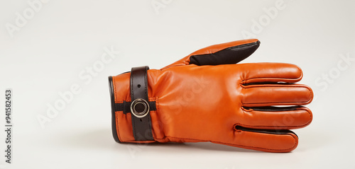 Detailed shot of men's brown leather gloves, featuring a harmonious mix of modern aesthetics and classic appeal. The luxurious leather and sleek design are perfect for enhancing fashion-related conten photo