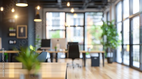 Modern open-plan office space with natural light streaming through large windows, featuring sleek furniture, plants, and ambient lighting for a productive atmosphere.