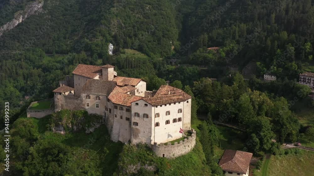 Slow flight point of interest Castle of Stenico. Rio bianco natural area waterfall in the background. Stenico Castle, with the Dolomites as a backdrop, showcasing its rich history and scenic beauty. Slow flight point of interest Castle of Stenico. Rio bianco natural area waterfall in the background. Stenico Castle, with the Dolomites as a backdrop, showcasing its rich history and scenic beauty.