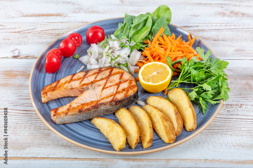 Turkish cuisine Grilled Salmon Steak with Thyme Branch. Grilled salmon steak with vegetables and tomato salad served on wooden table. Healthy food, keto diet food concept.Turkish name; Somon izgara. Turkish cuisine Grilled Salmon Steak with Thyme Branch. Grilled salmon steak with vegetables and tomato salad served on wooden table. Healthy food, keto diet food concept.Turkish name; Somon izgara.