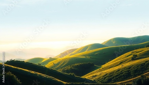 Sunrise over a lush green valley with rolling hills and a clear blue sky photo