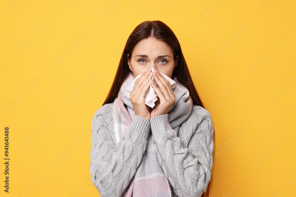 Sick woman with tissue on orange background. Cold symptoms Sick woman with tissue on orange background. Cold symptoms