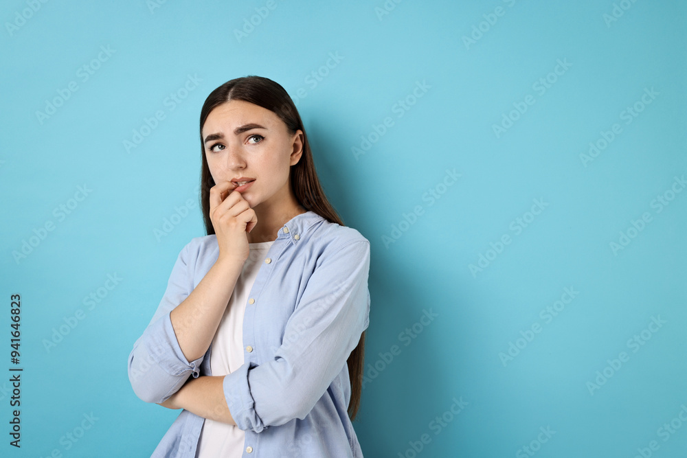 Portrait of scared woman on light blue background. Space for text Portrait of scared woman on light blue background. Space for text
