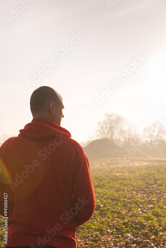 A man looking thoughtfully into the distance in the foggy autumn countryside