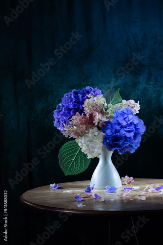 beautiful flowers in vase on vintage table in sunlight