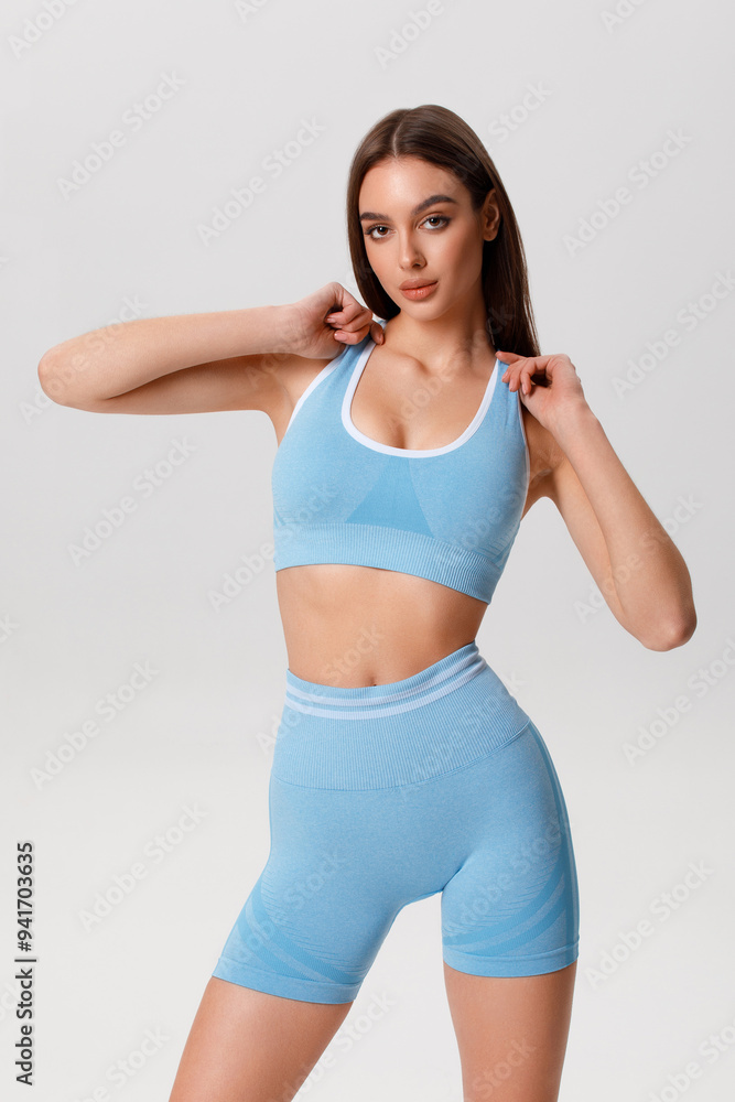 Fitness woman. Athletic girl on the gray background Fitness woman. Athletic girl on the gray background