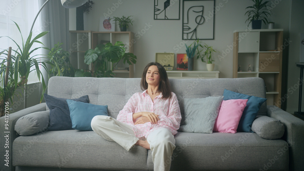 Woman relaxing on comfortable sofa in stylish Woman relaxing on comfortable sofa in stylish