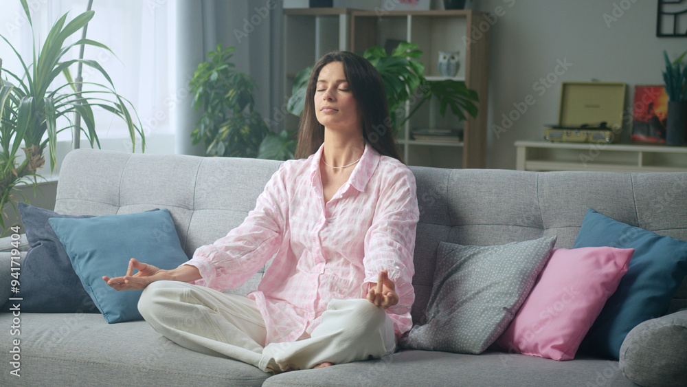 Young woman meditating while sitting in lotus Young woman meditating while sitting in lotus