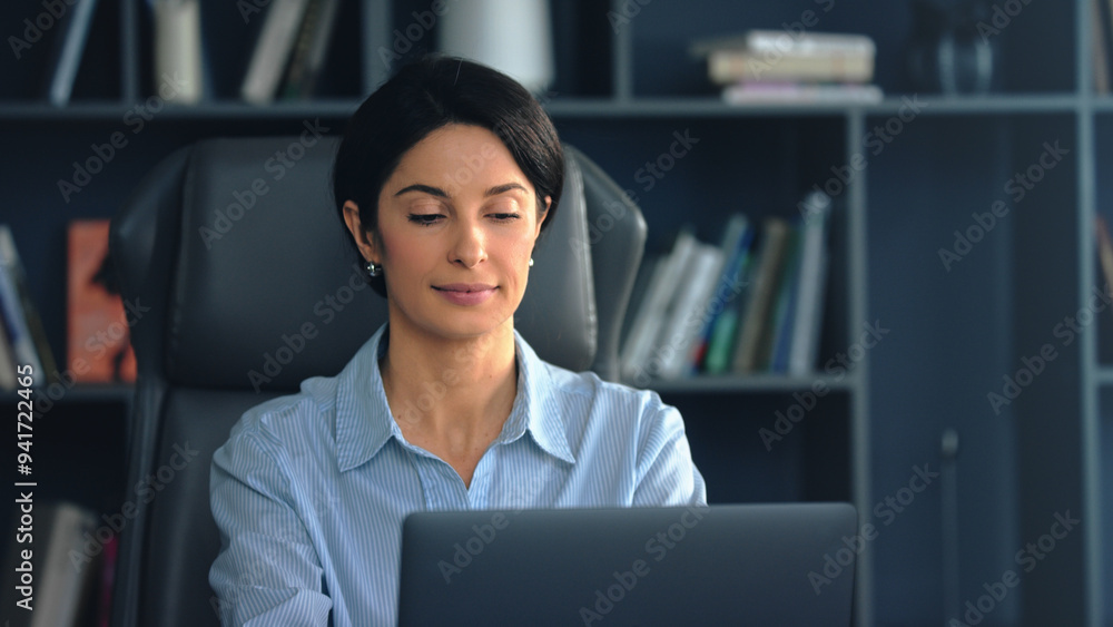 Businesswoman working on laptop in modern office Businesswoman working on laptop in modern office