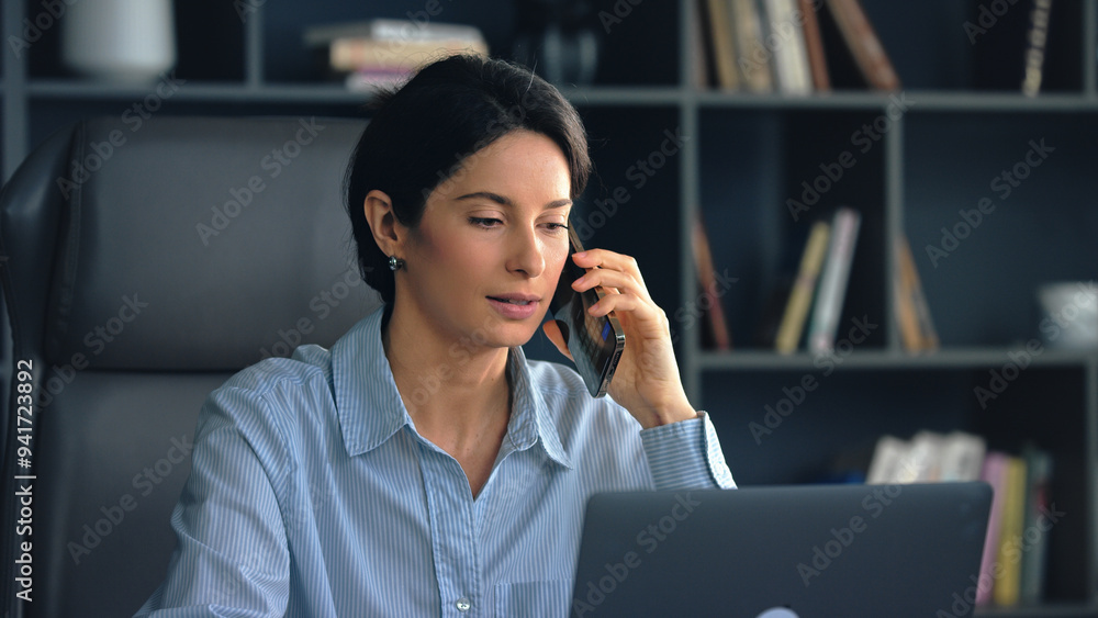 Businesswoman multitasking using laptop and Businesswoman multitasking using laptop and